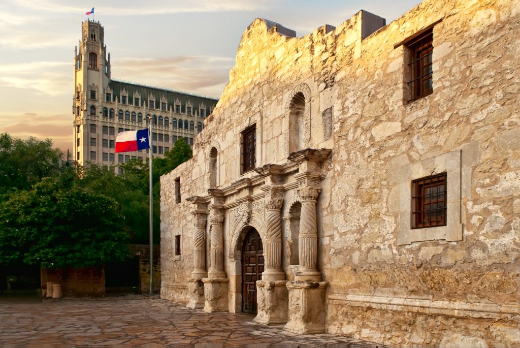 The front of the Alamo with the Emily Morgan hotel in the background.