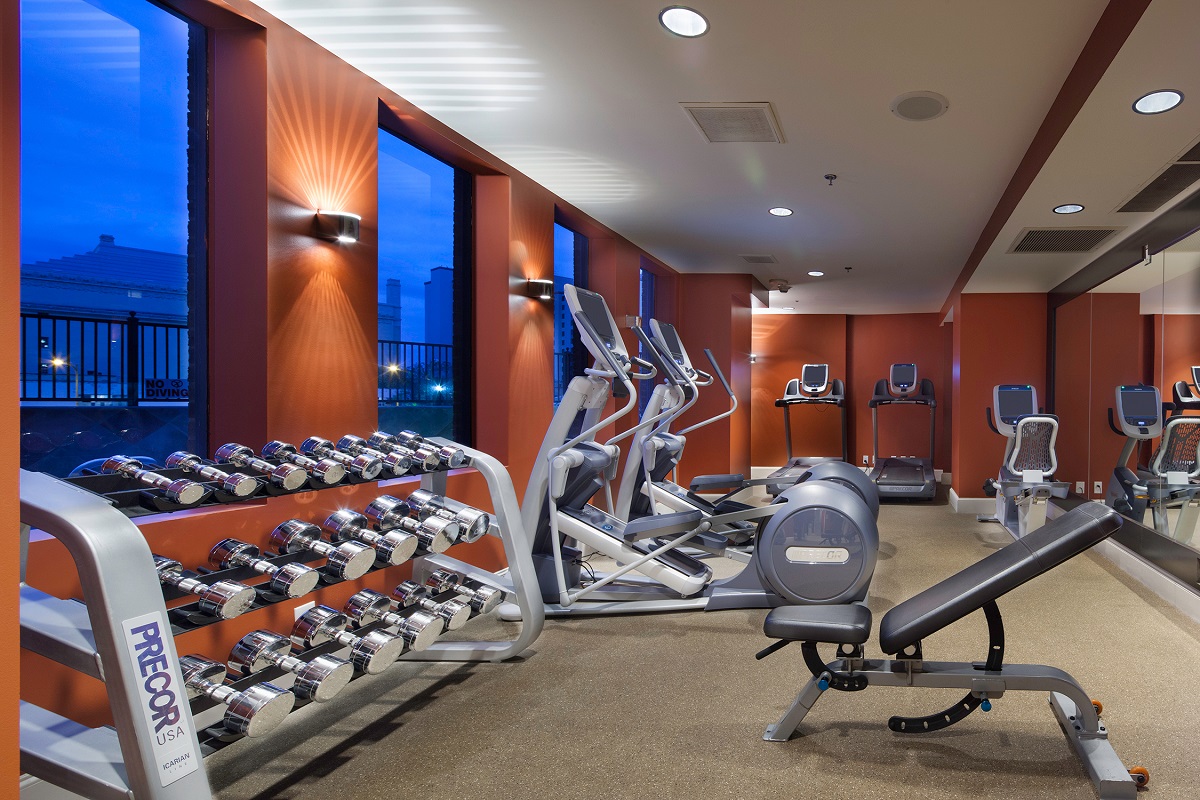 Fitness center with free weights, elliptical machines, and treadmills at The Emily Morgan hotel.