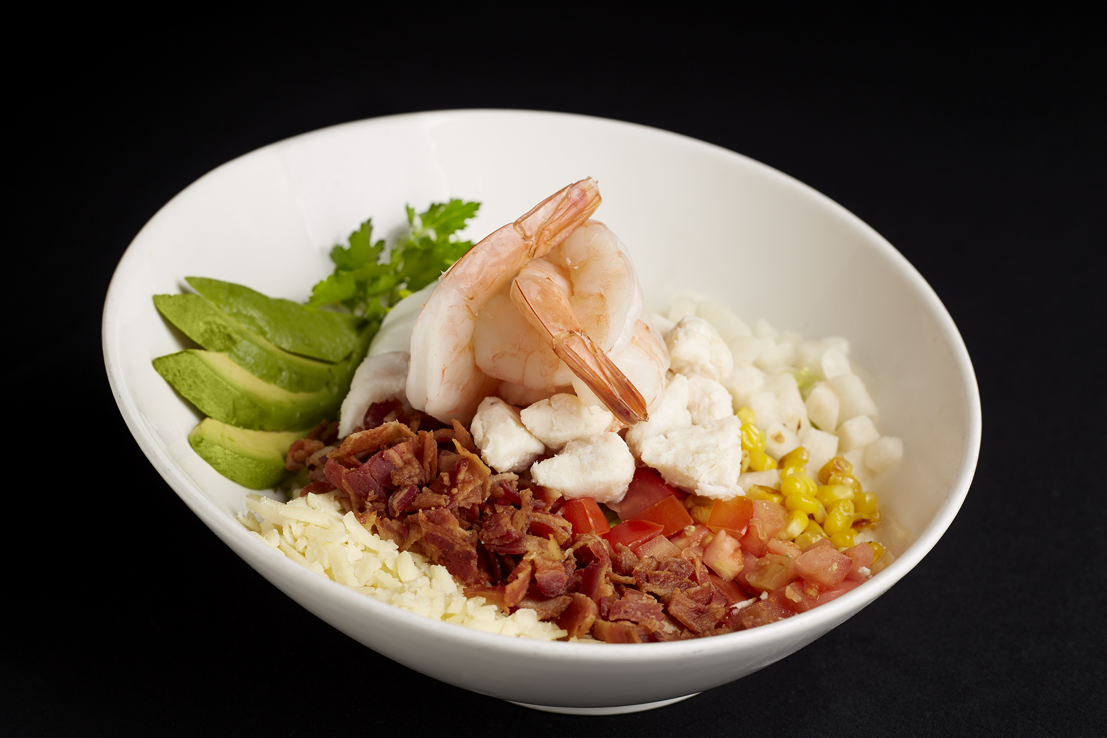 Shrimp bowl with rice, avocado, and corn at Oro Restaurant and Bar.