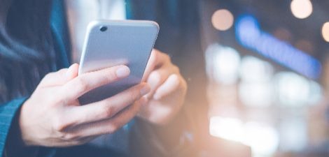 Close up of a person using a smartphone.