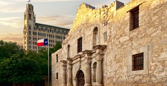 The Alamo, Texas flag, and the Emily Morgan hotel in the distance.