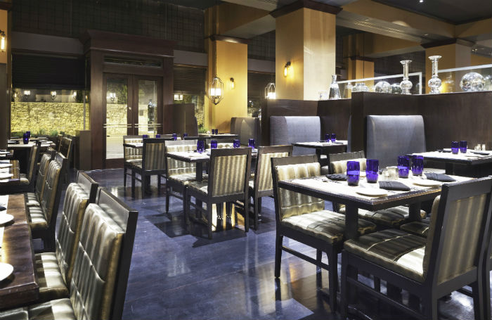 Tables and chairs in Oro Restaurant and Bar in the Emily Morgan Hotel.