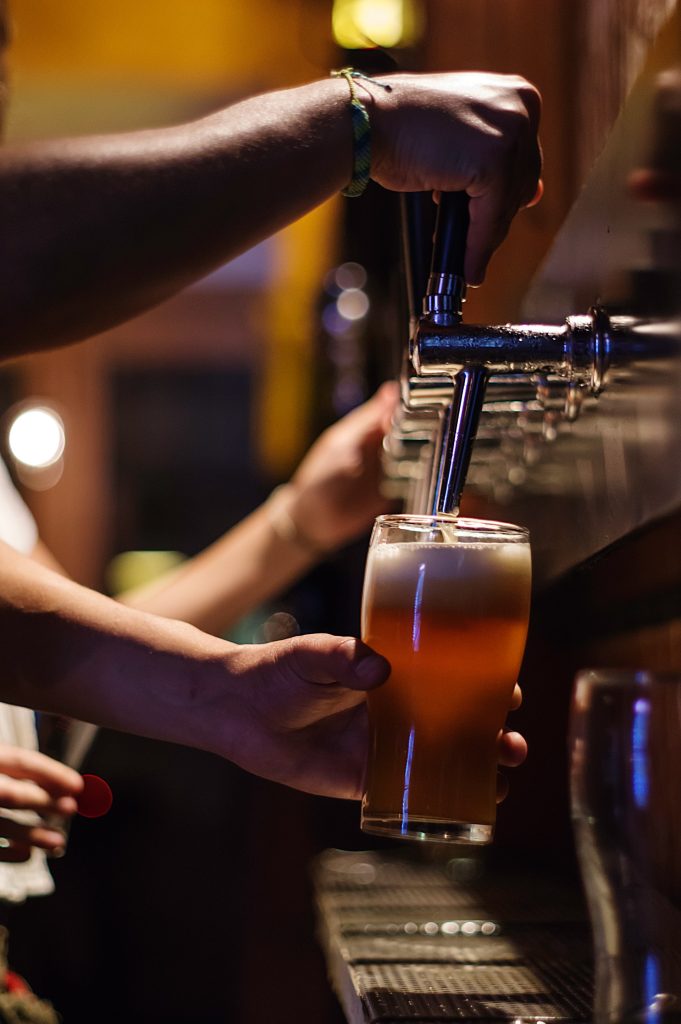 Pouring a glass of beer from the tap.