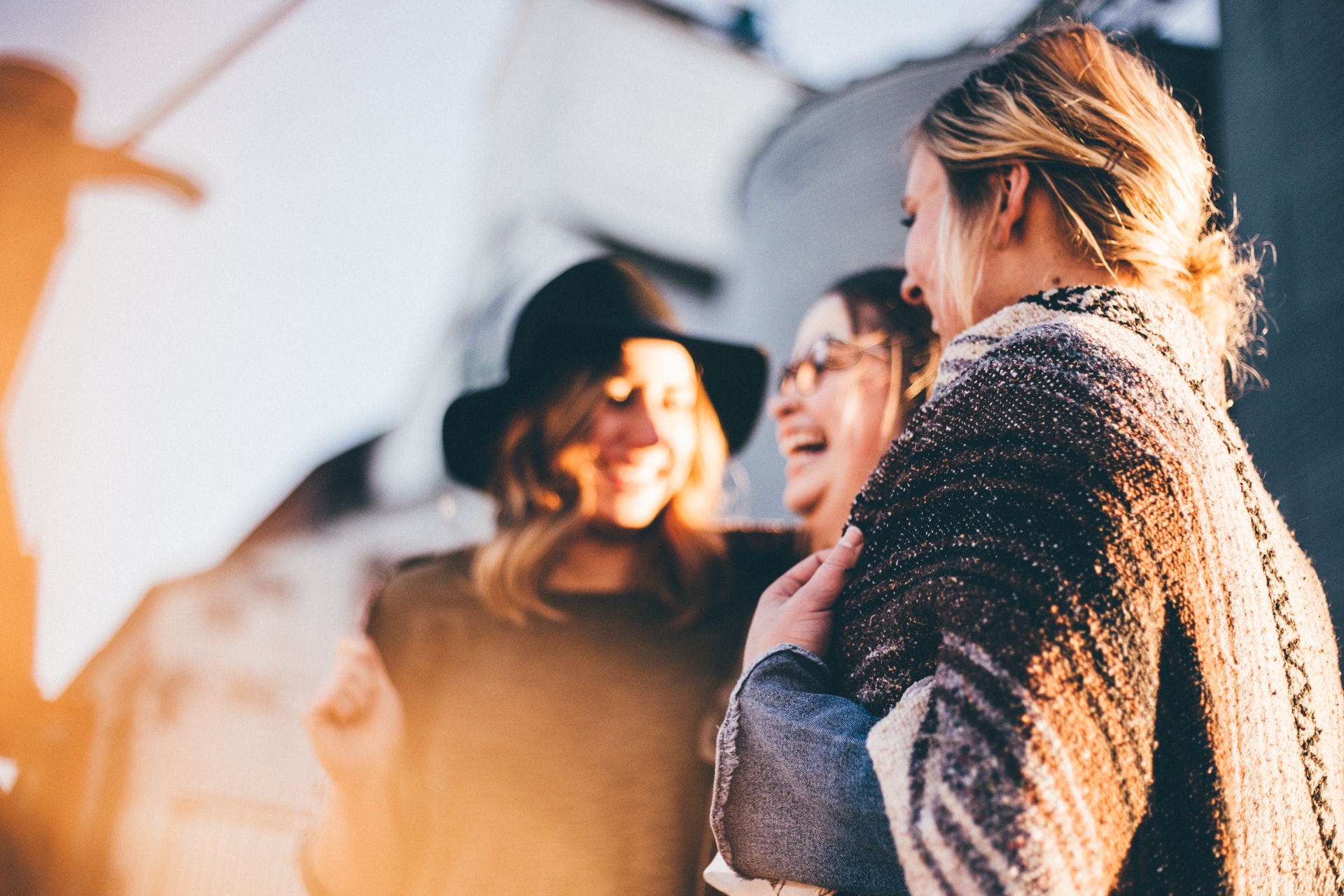 Three girls laughing together.