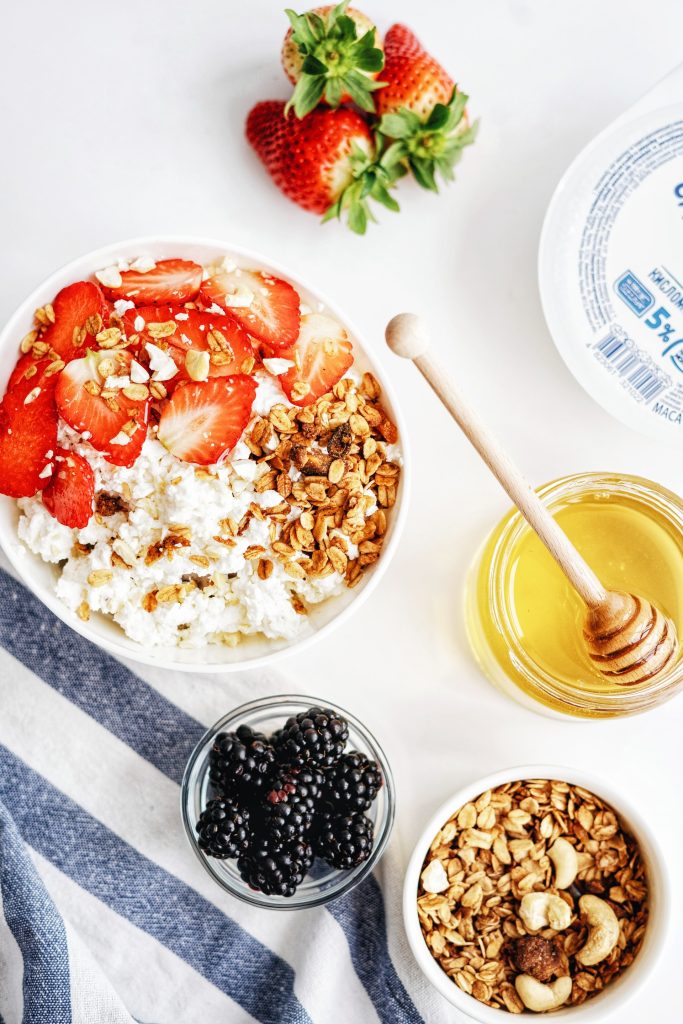 Yogurt, strawberries, blackberries, nuts and honey for breakfast.