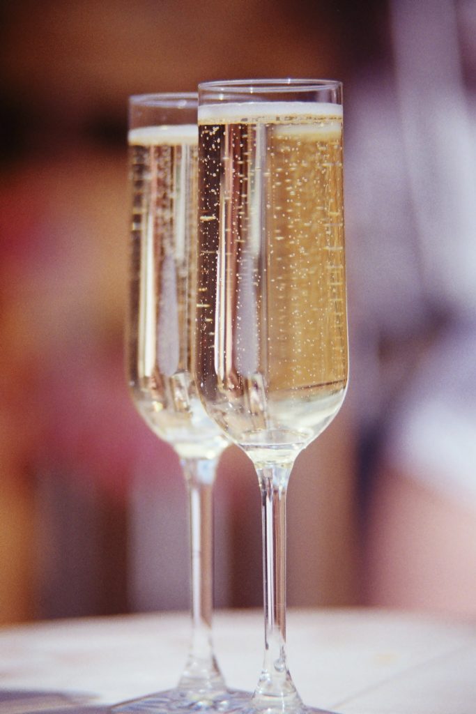 Two champagne glasses filled to the top.