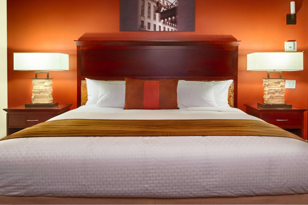 Bed and nightstands in a guestroom at the Emily Morgan Hotel.