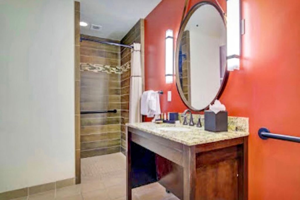 Accessible bathroom at the Emily Morgan Hotel, featuring a roll-in shower and accessible vanity.