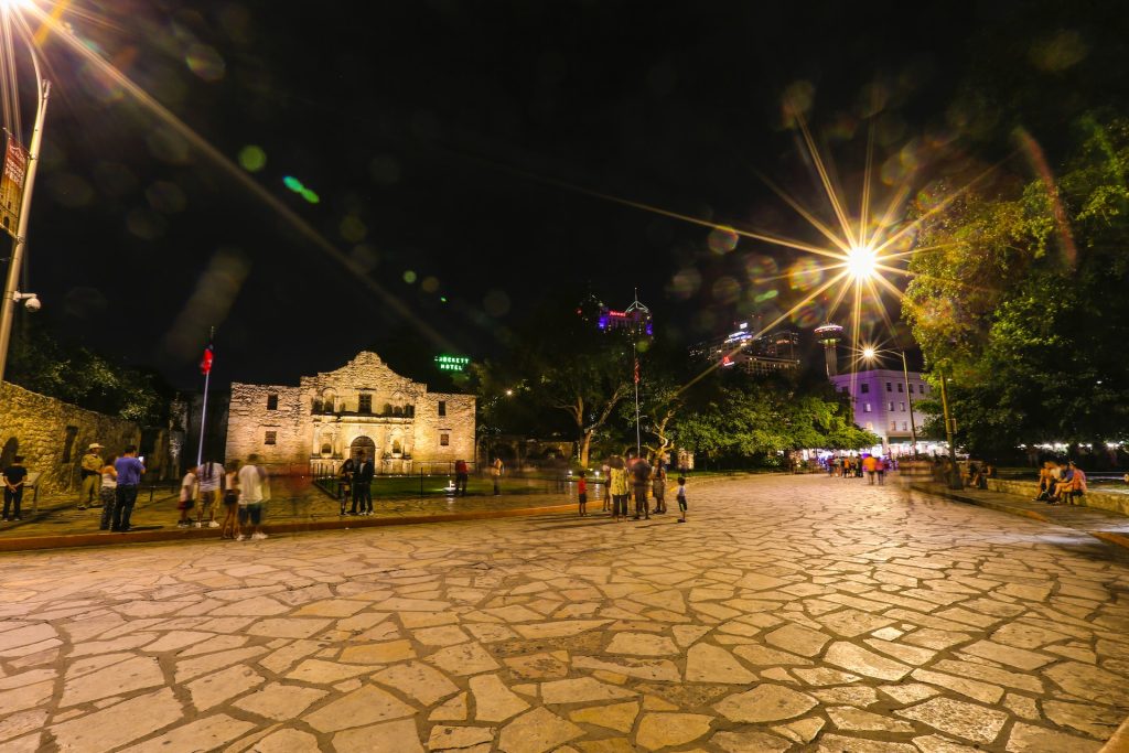 The Alamo and grounds at night.