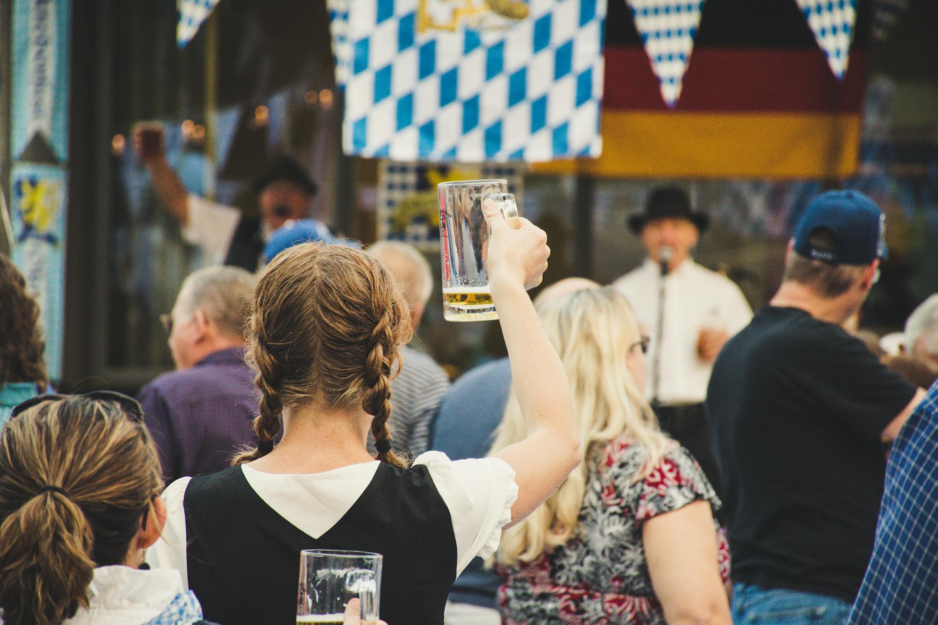 Woman at Oktoberfest, holding up an empty beer mug.