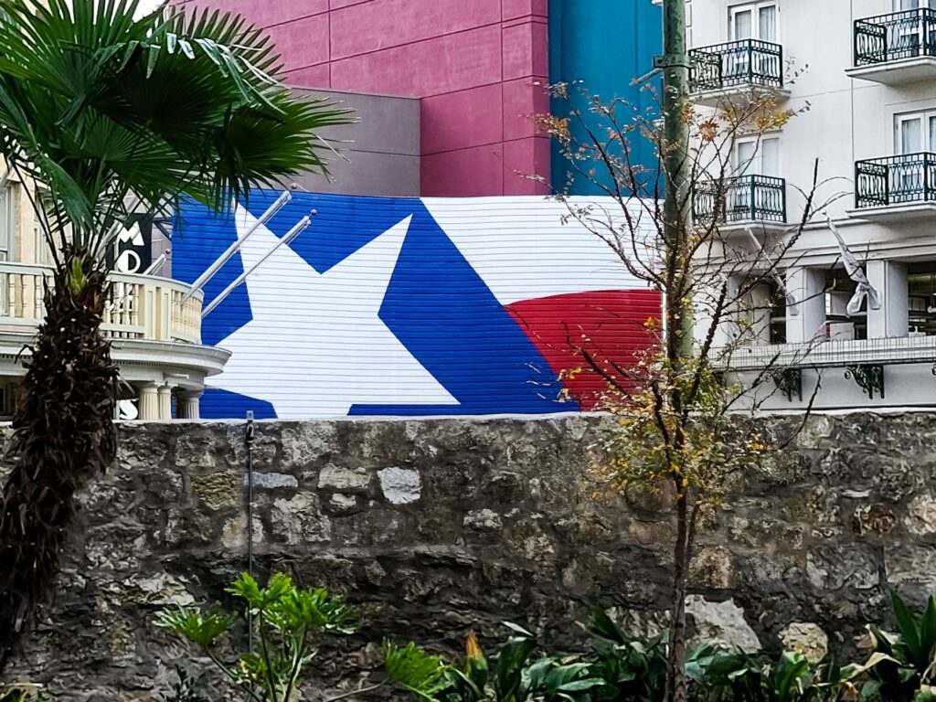 Mural of a Texas flag on the side of a building in San Antonio.